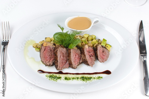 fillet mignon with sauce on a white plate