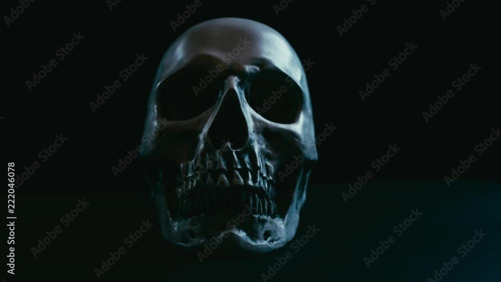 Skull in darkness,vertical stabilizer camera sudden movement with spot lights on and off Skull in darkness,vertical stabilizer camera sudden movement with spot lights on and off