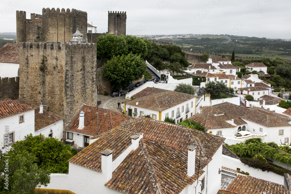 Village, medieval town, Obidos in Portugal. View of white houses, red tiles