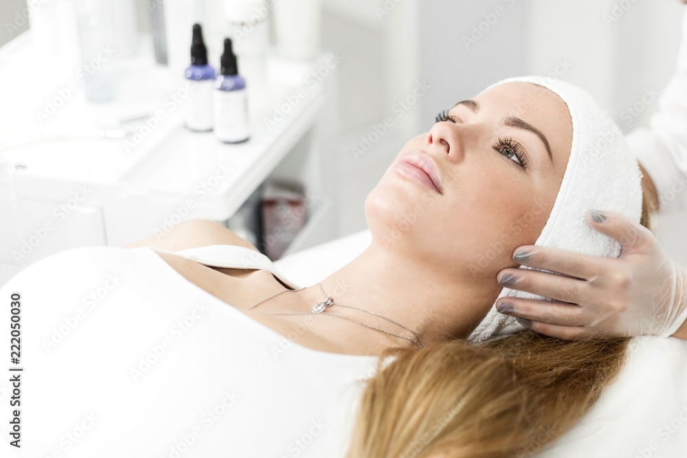 Girl patient lies on the procedure of rejuvenation of the skin in the Spa salon