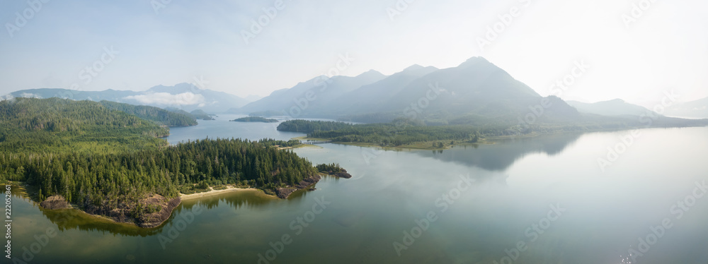 Obraz premium Aerial panoramic landscape view of Kennedy Lake during a cloudy summer day. Taken near Tofino and Ucluelet, Vancouver Island, BC, Canada.