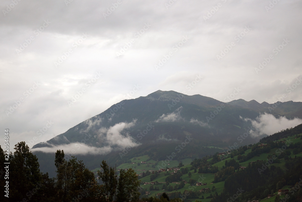 Mountains in the fog photographed on a pass road in Austria in autumn
