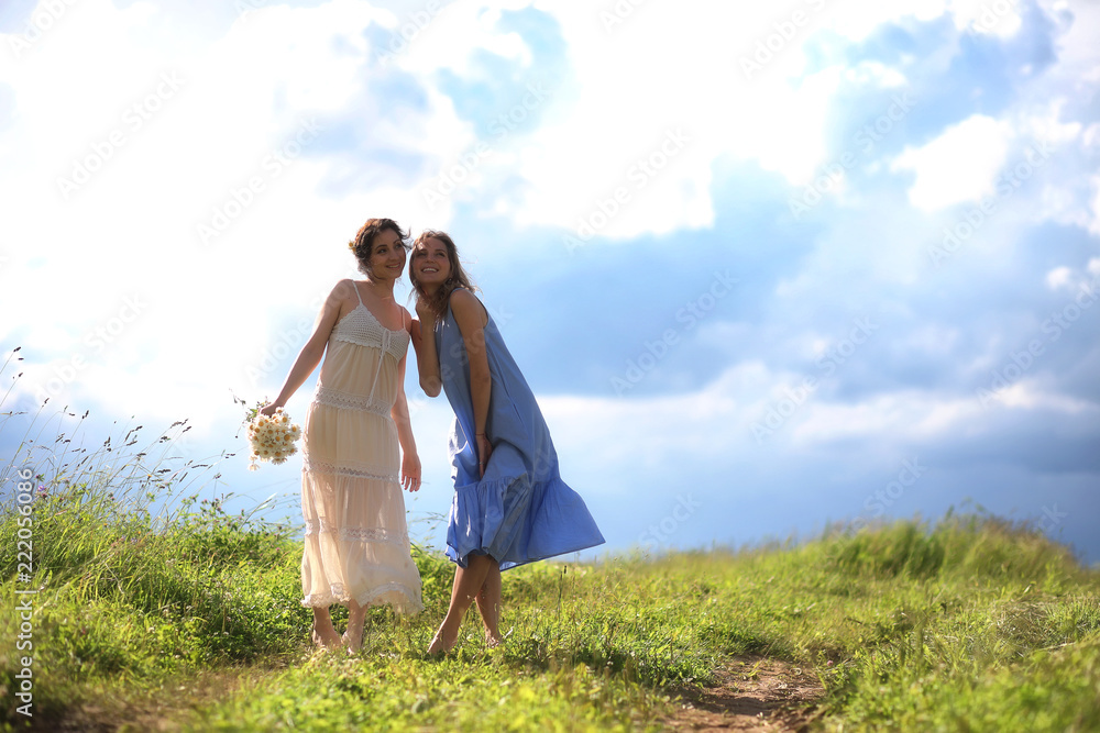 Young girls are walking in the field