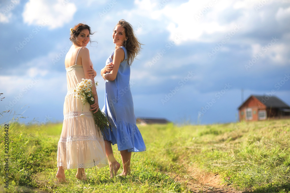 Young girls are walking in the field Young girls are walking in the field