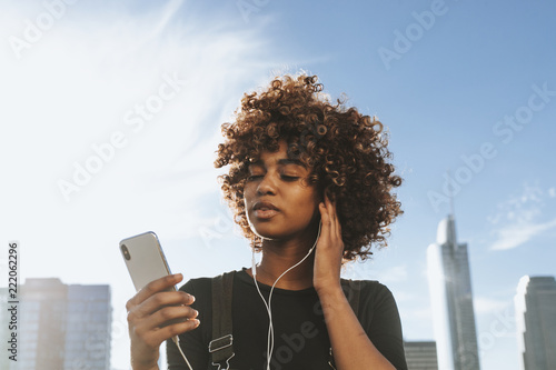 Girl listening to music from her phone photo