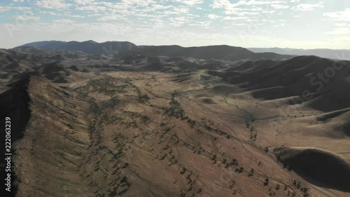 4K scenic panning shot over gorgeous savanna dotted with trees in the morning sun in Kunene namibia photo