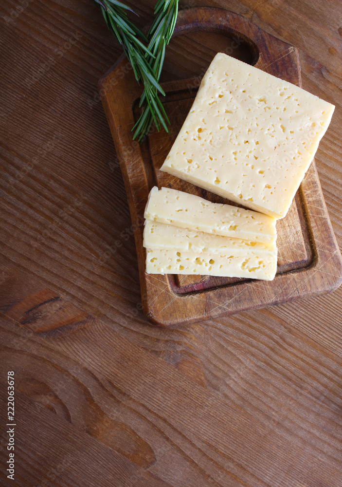cheese cut on a wooden background