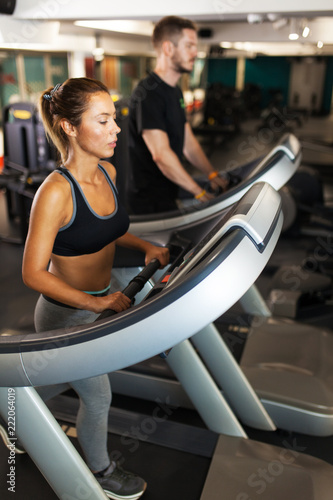 girl with fitness coach on a treadmill