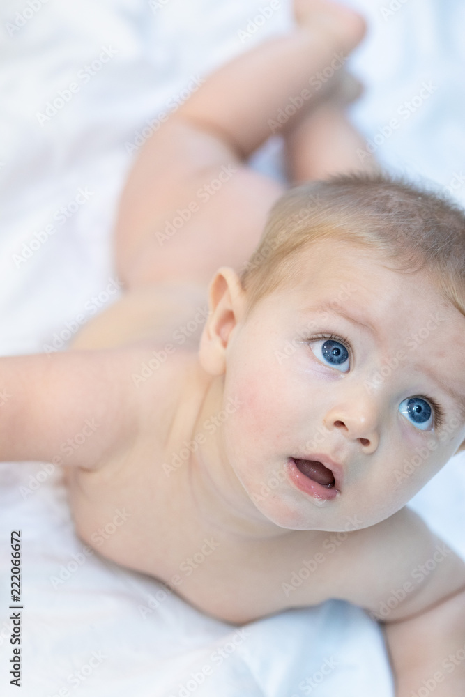 Curious calm little baby with large blue eyes Curious calm little baby with large blue eyes