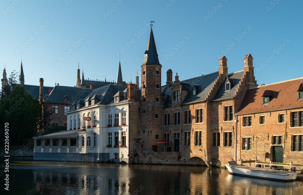 Old Bruges buildings reflecting in water canal in historical centre of Brugge, Belgium,