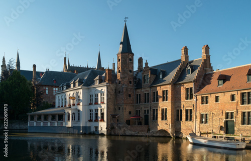 Old Bruges buildings reflecting in water canal in historical centre of Brugge, Belgium,