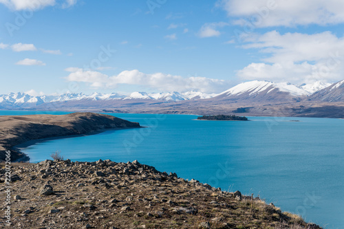 bay and mountains at Lake Tekapo while hiking the trail with island in view