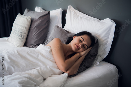 Good dreams make your day better. Attractive young woman sleeping joyfully photo