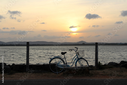 A bicycle and sunset around Bendiwewa Lake in Polonnaruwa © leodaphne