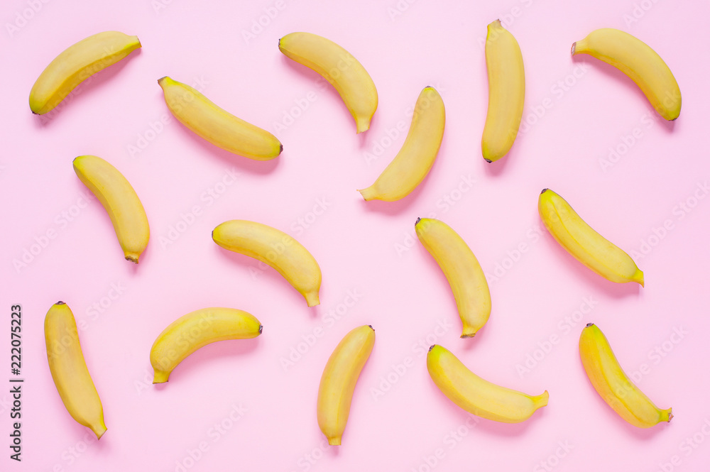 Pink background with small yellow bananas Pink background with small yellow bananas