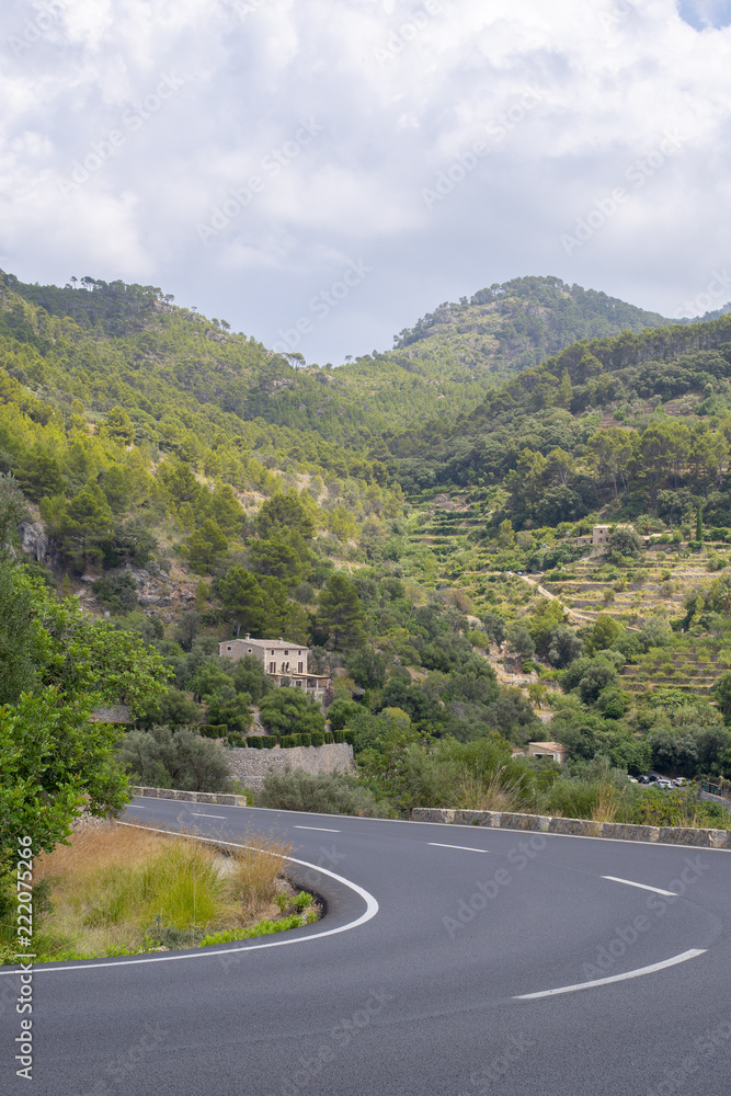 Scenic View of a Hill by the Side of an Asphalt Road
