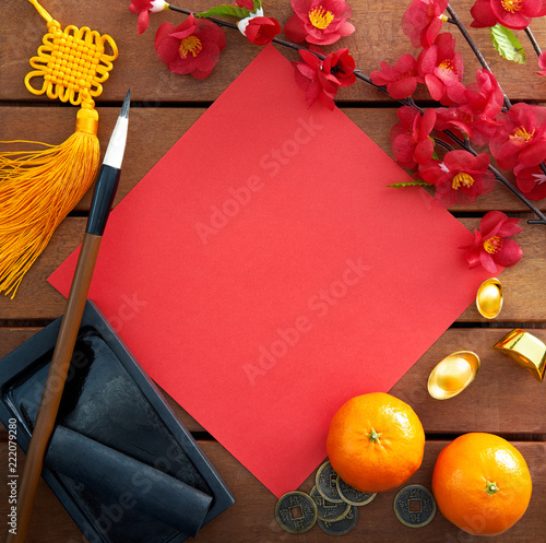 Chinese new year decorations with a blank red paper as copy space