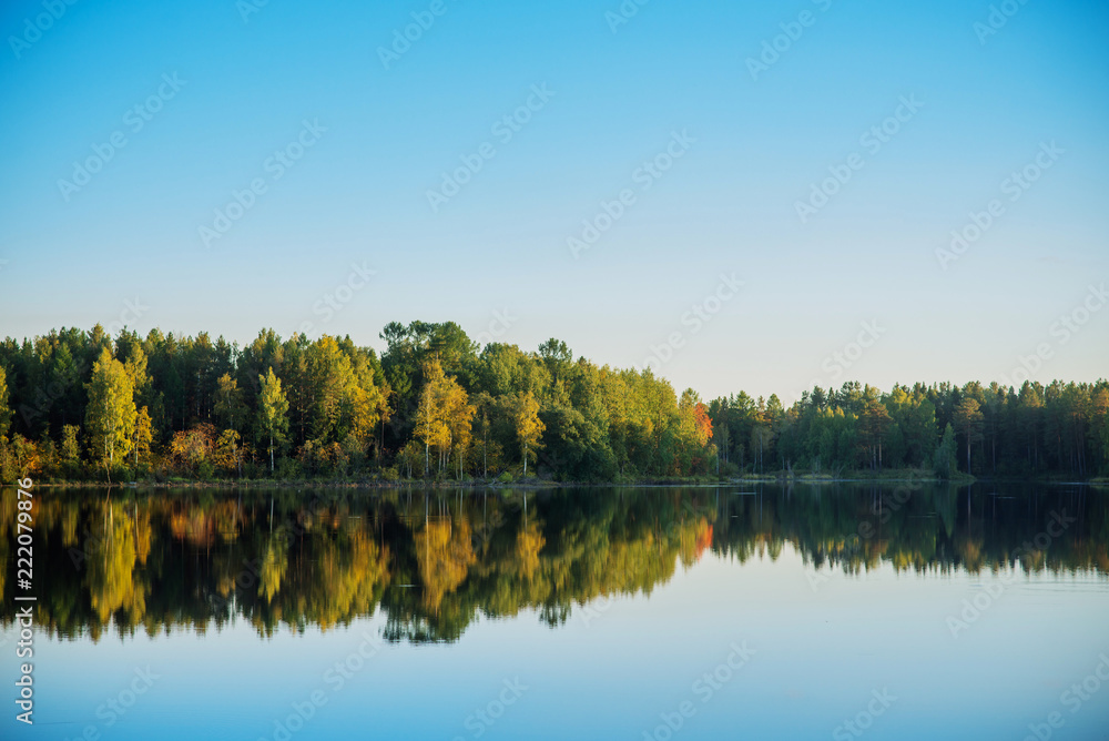natural background, landscape: Golden autumn, lake surrounded by forest with colorful leaves