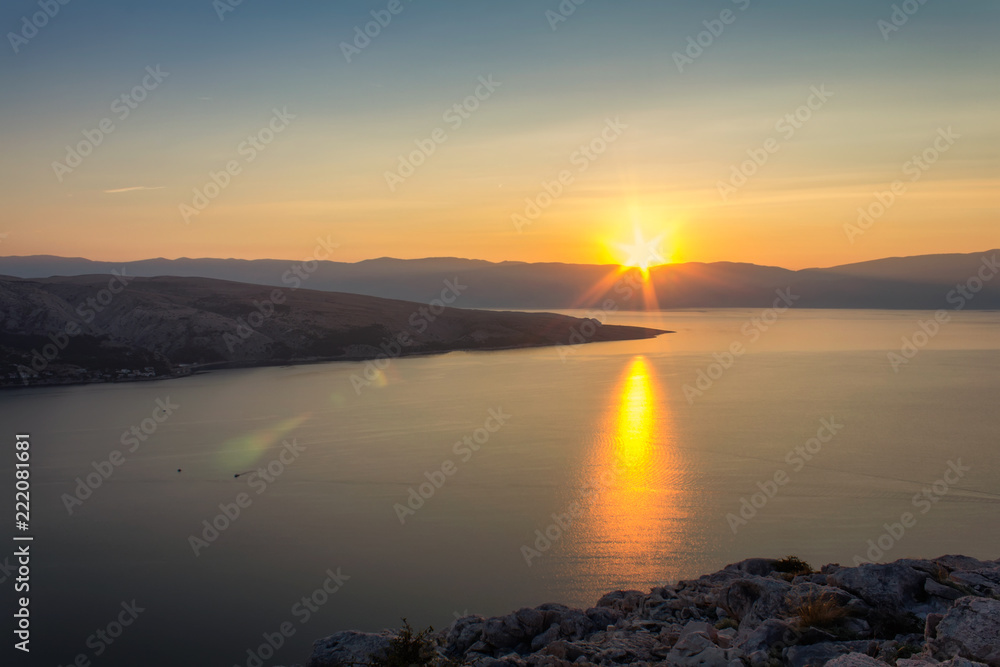 Nice sunset on sea with mountain, island Krk Croatia