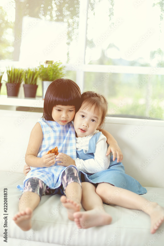 Cute asian little girl hug each other at home.