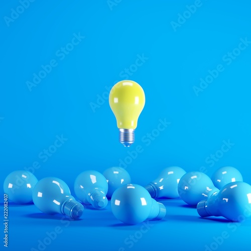 Yellow Lightbulb floating among blue lightbulb on background. minimal idea concept.