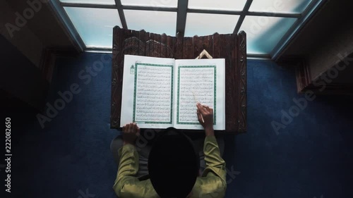 A muslim reading a quraan. photo