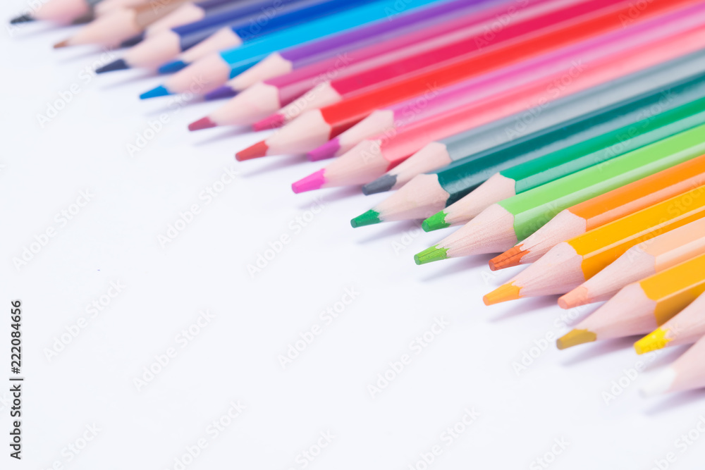 background of colored pencils spread out in the right, upper corner