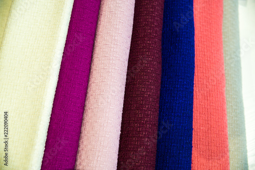 A multicolored stack of fabrics - the fabrics lie on top of each other