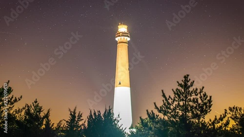Timelapse of stars moving across the night sky behind the historic Barnegat Lighthouse. photo