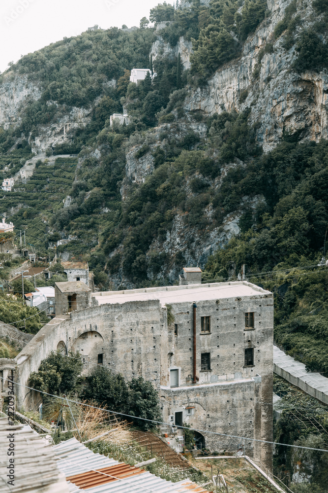 The Amalfi coast and the mountain slopes with plantations of lemons. Panoramic view of the city and nature of Italy. Evening landscapes and winding roads