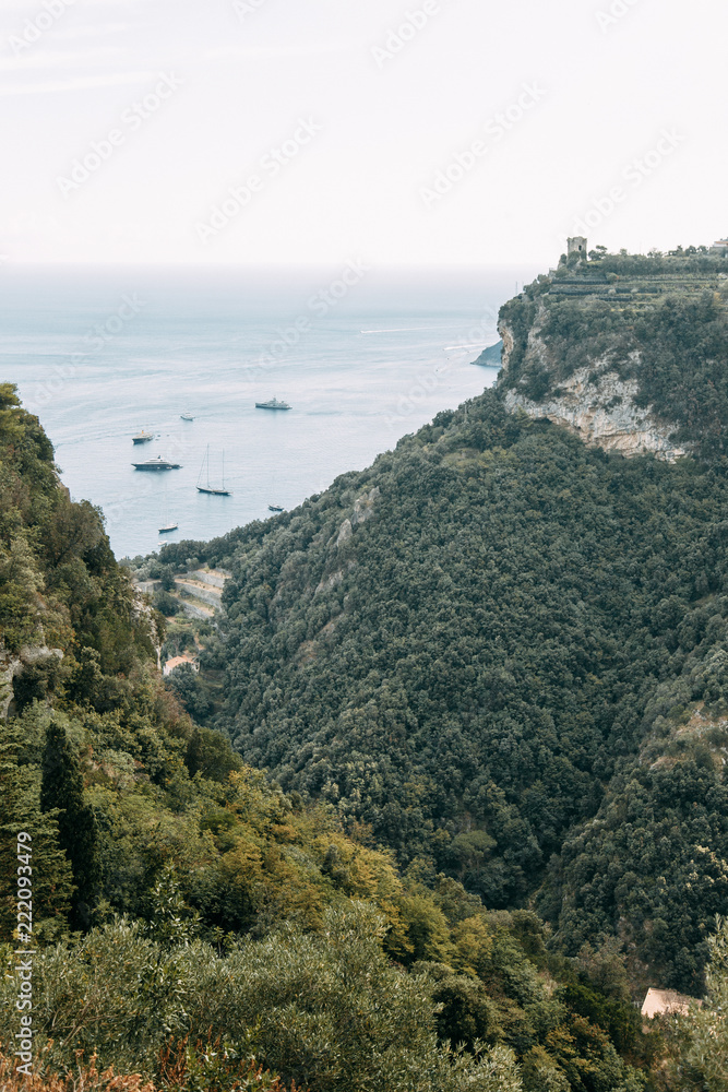 The Amalfi coast and the mountain slopes with plantations of lemons. Panoramic view of the city and nature of Italy. Evening landscapes and winding roads
