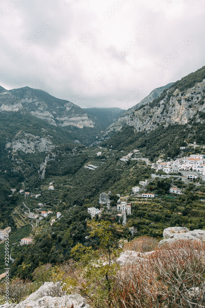 The Amalfi coast and the mountain slopes with plantations of lemons. Panoramic view of the city and nature of Italy. Evening landscapes and winding roads The Amalfi coast and the mountain slopes with plantations of lemons. Panoramic view of the city and nature of Italy. Evening landscapes and winding roads