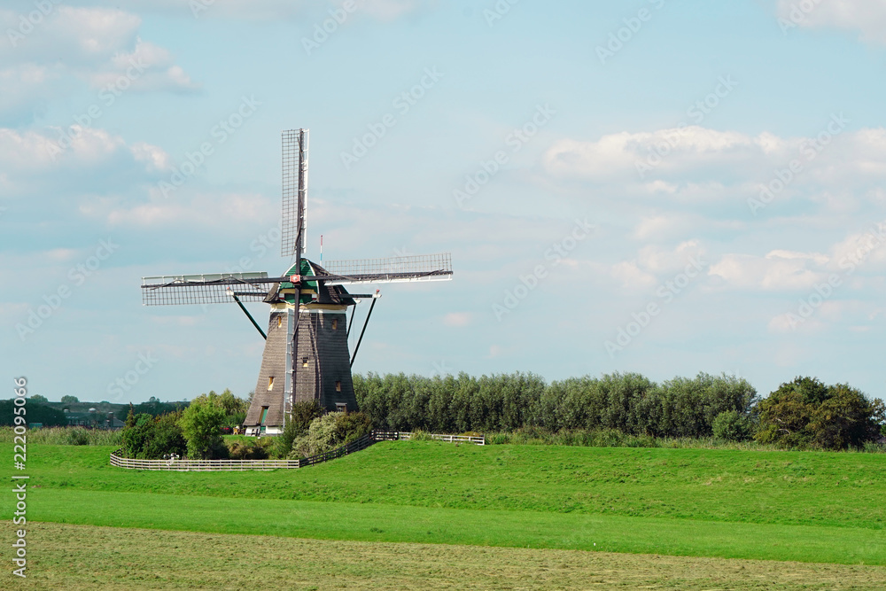 Obraz premium Old windmill against the blue sky in the morning in the summer. An old white mill. 