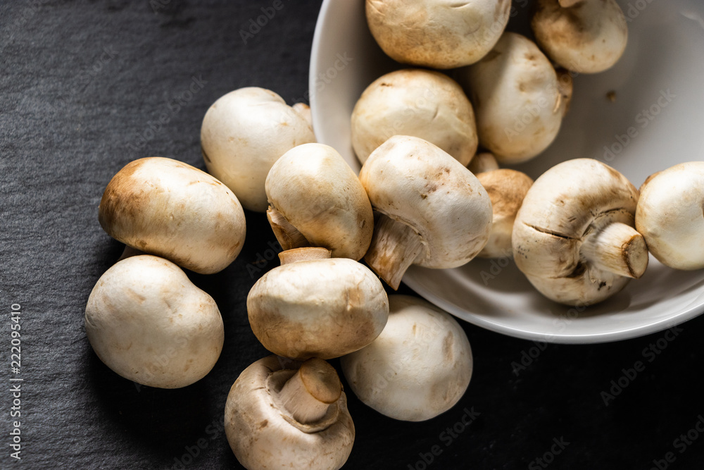 Fresh White Mushrooms Spilling Out Of Bowl Fresh White Mushrooms Spilling Out Of Bowl