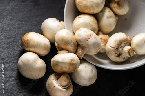 Fresh White Mushrooms Spilling Out Of Bowl