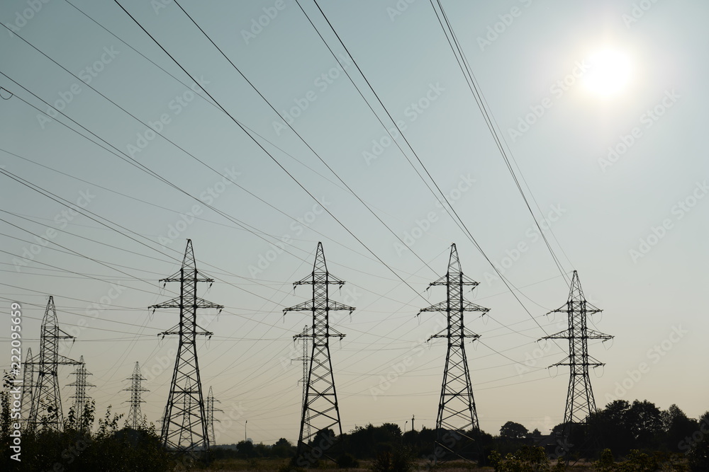Electricity transmission pylons in sunset