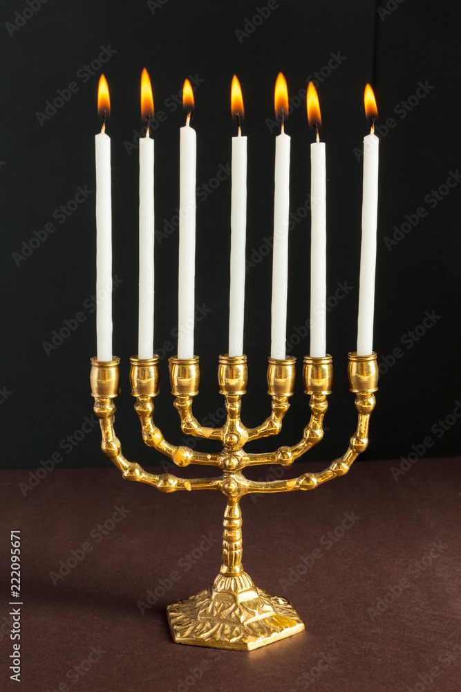 Bronze Hanukkah menorah with burning candles Bronze Hanukkah menorah with burning candles