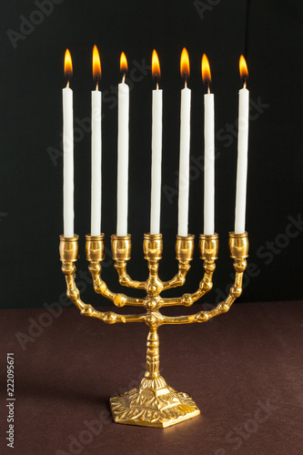 Bronze Hanukkah menorah with burning candles