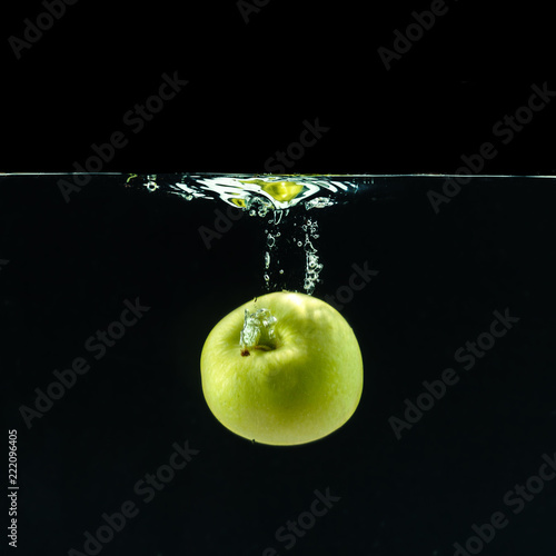 Green apple under water