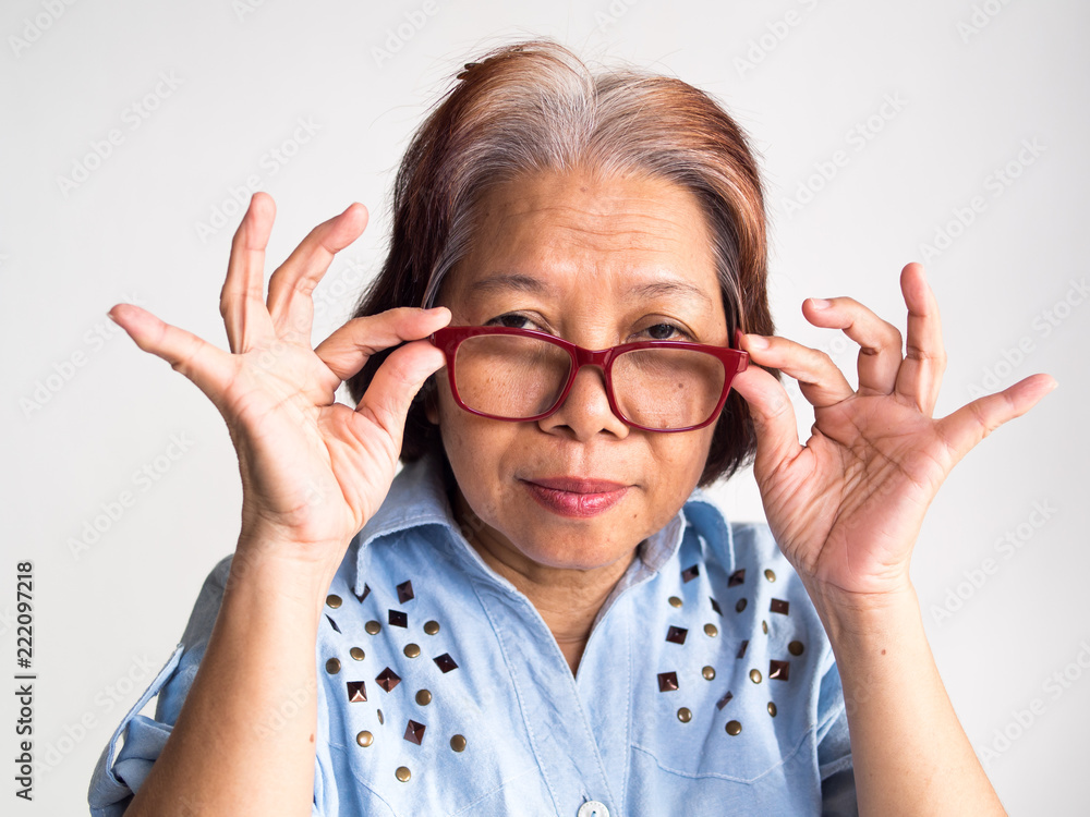 Senior retirement elderly old southeast Asia Asian women hold a eyeglasses look at camera with confused emotions can use in healthy insurance retire people medical coaching financial planning concept Senior retirement elderly old southeast Asia Asian women hold a eyeglasses look at camera with confused emotions can use in healthy insurance retire people medical coaching financial planning concept