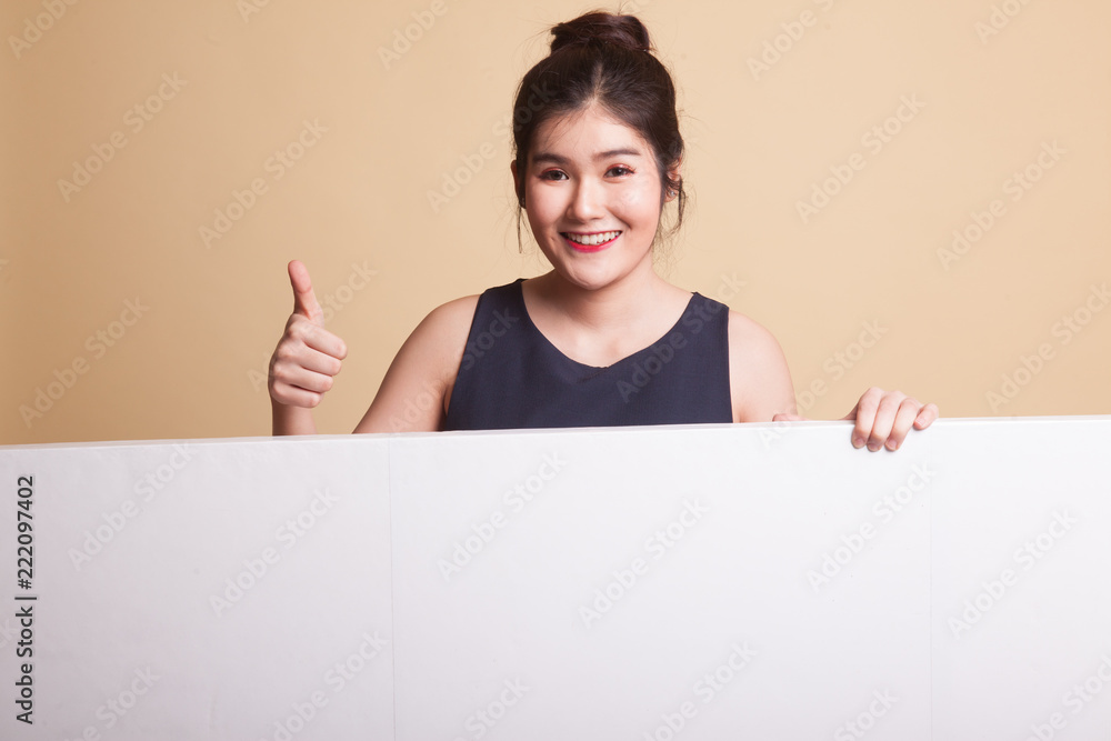 Young Asian woman show thumbs up with blank sign. Young Asian woman show thumbs up with blank sign.