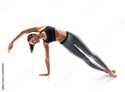 Silhouette of slim girl practicing yoga isolated on white background. Concept of healthy life and natural balance between body and mental development. Full length