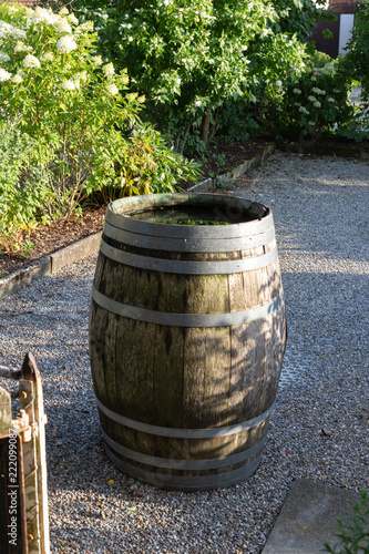 wooden waterdrum in cottage garden photo