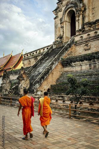 Monks walking by Wat Chedi Luang Temple in Chiang Mai