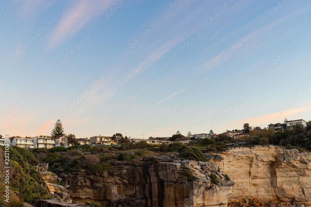 Residential suburb along the cliff coastline with morning cloudy sky.
