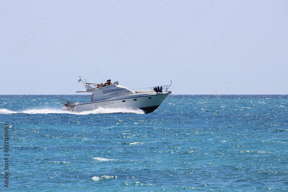 Torre Mozza (Ugento), Lecce, Italy - August 15, 2016 - Day at the seaside, with sports and entertainment (kite surfing, wind surfing and yatch), in August in Salento Torre Mozza (Ugento), Lecce, Italy - August 15, 2016 - Day at the seaside, with sports and entertainment (kite surfing, wind surfing and yatch), in August in Salento