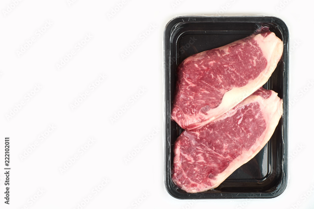 Raw steak in an airtight vacuum package on a white background. Raw steak in an airtight vacuum package on a white background.