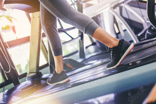 Woman walking in machine treadmill prepare for jogging at fitness gym