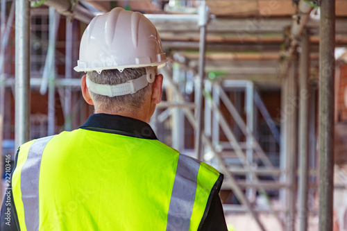 Rear View of a Construction Worker on Building Site photo