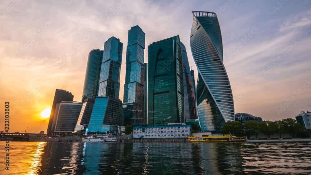 Business center Moscow City with modern futuristic skyscrapers buildings reflected in river in summer evening at sunset time, 4K time lapse, toned